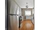 Bright kitchen with stainless steel appliances, white cabinetry, and hardwood floors at 3970 Broadway St, Indianapolis, IN 46205