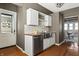 Bright kitchen with stainless steel sink, white cabinets, butcher block counters and view into dining room at 3970 Broadway St, Indianapolis, IN 46205
