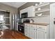 Kitchen with stainless steel appliances, white cabinets, butcher block countertops and view to dining area at 3970 Broadway St, Indianapolis, IN 46205