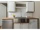 Bright kitchen features white cabinets, butcher block countertops, and stainless steel farm sink at 3970 Broadway St, Indianapolis, IN 46205