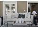 Cozy living room featuring a comfortable sofa with decorative pillows and a stylish glass coffee table at 3970 Broadway St, Indianapolis, IN 46205