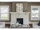 Bright living room with painted brick fireplace, modern art, and large windows at 3970 Broadway St, Indianapolis, IN 46205