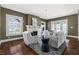 Comfortable living room with hardwood floors, white painted fireplace, and ample seating for entertaining guests at 3970 Broadway St, Indianapolis, IN 46205