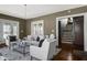 Open living room featuring hardwood floors, neutral decor, and access to the staircase providing a welcoming space at 3970 Broadway St, Indianapolis, IN 46205