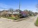 Street corner view of the two-story house, including a street sign at 3970 Broadway St, Indianapolis, IN 46205