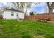 Large backyard with green grass, picnic table, fire pit, and back of house at 4547 Farrington Ave, Indianapolis, IN 46201