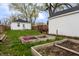 Backyard area featuring a garden, the back of a white home, and a trailer at 4547 Farrington Ave, Indianapolis, IN 46201