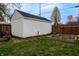 White storage building backyard with a trailer next to garden boxes at 4547 Farrington Ave, Indianapolis, IN 46201