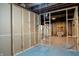 Unfinished basement with stud framing, exposed ceiling, and installed walls at 4547 Farrington Ave, Indianapolis, IN 46201