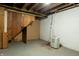 Unfinished basement space with exposed ceiling and utilities, dehumidifier and concrete floor at 4547 Farrington Ave, Indianapolis, IN 46201
