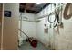 Basement space featuring exposed pipes and utilities, staff restroom door on the left at 4547 Farrington Ave, Indianapolis, IN 46201