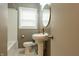 Modern bathroom with stylish pedestal sink, gold faucet, and contemporary subway tile in the shower at 4547 Farrington Ave, Indianapolis, IN 46201