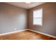 Bedroom features original hardwood floors, ceiling fan, and window with white blinds at 4547 Farrington Ave, Indianapolis, IN 46201