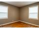 Bedroom features two windows with white blinds and original hardwood floors at 4547 Farrington Ave, Indianapolis, IN 46201