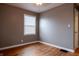 Bedroom features original hardwood floors, closet, and window with white blinds at 4547 Farrington Ave, Indianapolis, IN 46201