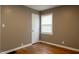 Bedroom features original hardwood floors, closet, and window with white blinds at 4547 Farrington Ave, Indianapolis, IN 46201
