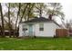 Neat single-story home featuring a well-maintained front lawn, adorned with a light blue front door at 4547 Farrington Ave, Indianapolis, IN 46201