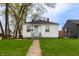 Charming single-story home featuring a neatly manicured front yard, complemented by a light blue front door at 4547 Farrington Ave, Indianapolis, IN 46201
