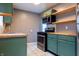 Stylish kitchen boasting stainless steel appliances, green cabinets, and butcher block countertops at 4547 Farrington Ave, Indianapolis, IN 46201