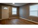 Bright living room featuring refinished hardwood floors, light grey paint, and large windows at 4547 Farrington Ave, Indianapolis, IN 46201