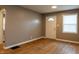 Inviting living room boasting refinished hardwood floors, neutral paint, and abundant natural light at 4547 Farrington Ave, Indianapolis, IN 46201