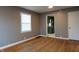 Cozy living room with refinished hardwood floors, light grey paint, and seamless access to the kitchen at 4547 Farrington Ave, Indianapolis, IN 46201
