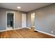 Spacious living room features refinished hardwood floors and seamless transition to the kitchen at 4547 Farrington Ave, Indianapolis, IN 46201