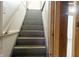 Basement stairway featuring painted steps and unfinished walls at 4547 Farrington Ave, Indianapolis, IN 46201