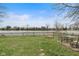 Inviting backyard features well-maintained lawn, patio area, fire pit, and peaceful water views at 49 Fountain Lake Dr, Greenfield, IN 46140