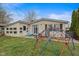 Charming backyard with lush lawn, small patio, and mature trees creating a private outdoor space at 49 Fountain Lake Dr, Greenfield, IN 46140