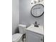 Clean bathroom features a modern round mirror above a stylish white sink and vanity at 49 Fountain Lake Dr, Greenfield, IN 46140