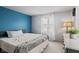 Cozy bedroom featuring a queen bed, bright blue accent wall, and natural light from the window at 49 Fountain Lake Dr, Greenfield, IN 46140