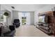 Bright living room with hardwood floors, sliding glass doors, and a decorative brick fireplace at 49 Fountain Lake Dr, Greenfield, IN 46140