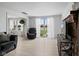 Bright living room with hardwood floors, sliding glass doors, and a decorative brick fireplace at 49 Fountain Lake Dr, Greenfield, IN 46140