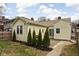 Backyard of home with a patio and landscaping including small evergreen trees at 5252 N College Ave, Indianapolis, IN 46220