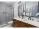 Bright and clean, this bathroom features a double vanity and glass enclosed shower at 5252 N College Ave, Indianapolis, IN 46220