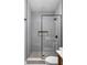 Walk-in shower features gray tile and black hardware in this newly renovated bathroom at 5252 N College Ave, Indianapolis, IN 46220