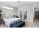 Bedroom features neutral walls, carpet and a padded headboard plus a door to the en suite at 5252 N College Ave, Indianapolis, IN 46220