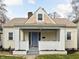 Charming home featuring a gabled roof, covered porch with brick accents, and a well-maintained front yard at 5252 N College Ave, Indianapolis, IN 46220