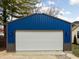 Exterior of the blue garage features a white garage door and gray trim at 5252 N College Ave, Indianapolis, IN 46220