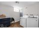 Bright laundry room with new washer and dryer, storage, and natural light at 5252 N College Ave, Indianapolis, IN 46220