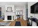 Bright living room showcasing a fireplace, hardwood floors, and seamless flow to dining area at 5252 N College Ave, Indianapolis, IN 46220
