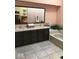 Spacious bathroom features dual sinks, tiled floors, and a separate soaking tub for ultimate relaxation at 5329 Hawks Point Rd, Indianapolis, IN 46226