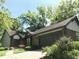A brick and siding home with an attached garage and mature landscaping at 5329 Hawks Point Rd, Indianapolis, IN 46226