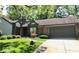 A single-story home with mature landscaping and a two-car attached garage at 5329 Hawks Point Rd, Indianapolis, IN 46226