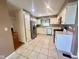 This kitchen features stainless steel appliances, tiled floors, and white cabinets for a clean, classic design at 5329 Hawks Point Rd, Indianapolis, IN 46226