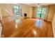 Bright living room boasts hardwood floors, a fireplace, and large windows that offer a refreshing view at 5329 Hawks Point Rd, Indianapolis, IN 46226
