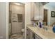 Well-lit bathroom with a tiled shower, toilet, and a vanity with a marble-like countertop at 5333 Thicket Hill Ln, Indianapolis, IN 46226