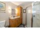 Well-lit bathroom featuring a walk-in shower and a sink with a wooden cabinet at 5333 Thicket Hill Ln, Indianapolis, IN 46226