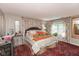 Cozy bedroom with floral curtains, patterned bedding, and a traditional rug at 5333 Thicket Hill Ln, Indianapolis, IN 46226